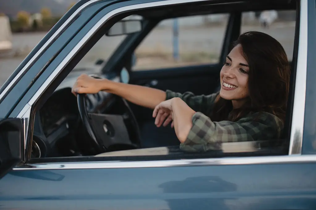 Happy traveler enjoying car rental experience